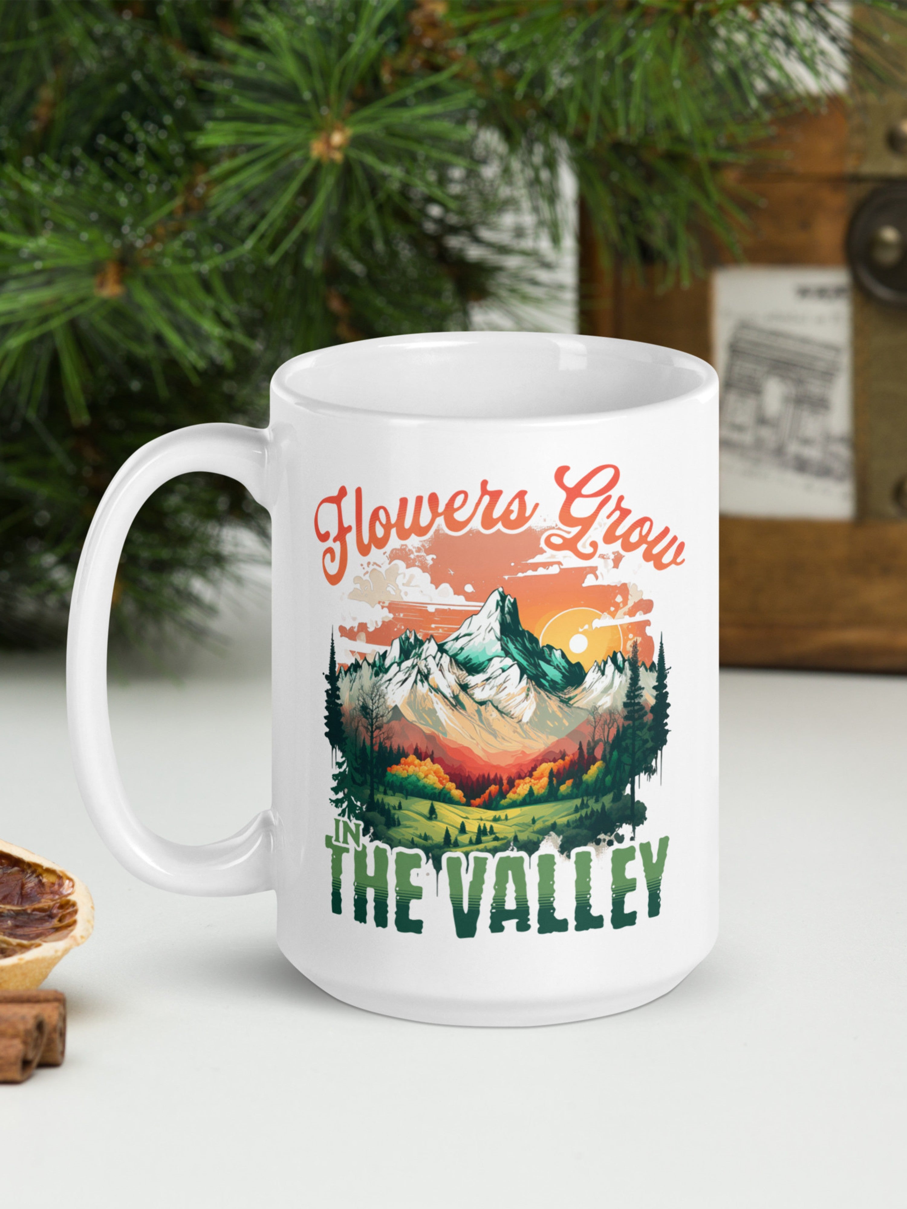 White mug with mountains and 'Flowers Grow in the Valley' scenic artwork